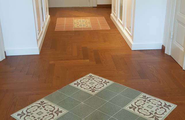 Carpet of cement tiles with hardwood floors